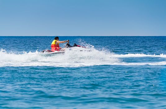 The young man quickly goes by sea water scooter