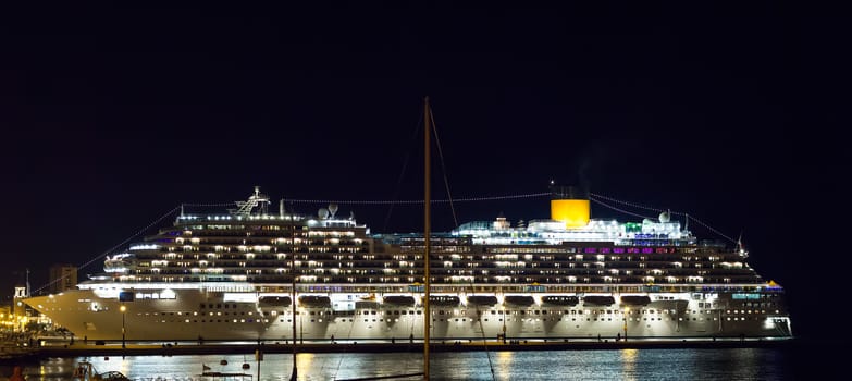 Night view of cruise ship illuminated docked in the Trieste pier