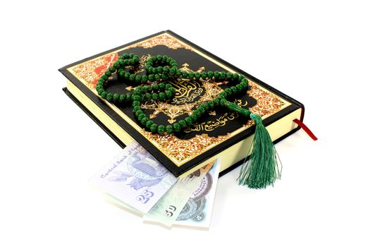 whipped Quran with Egyptian piastre before light background