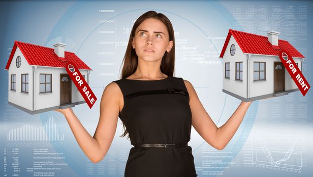 Businesswoman holding two house with tags for sale and rent. Hi-tech graphs as backdrop. Business concept