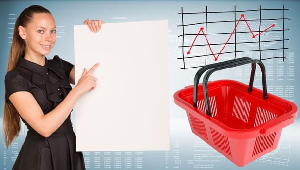 Beautiful businesswoman in dress smiling and holding empty paper sheet. Red shopping basket are located near. Graph as backdrop