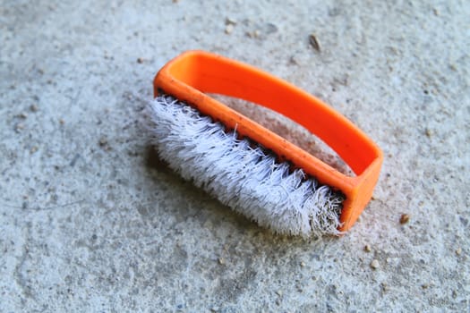 old plastic brush which have the orange handle.