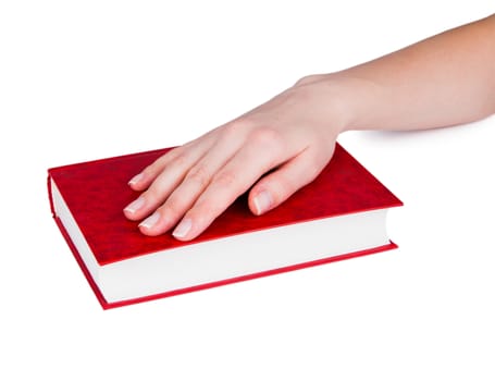 Women's hand on a closed book, isolated on white background.