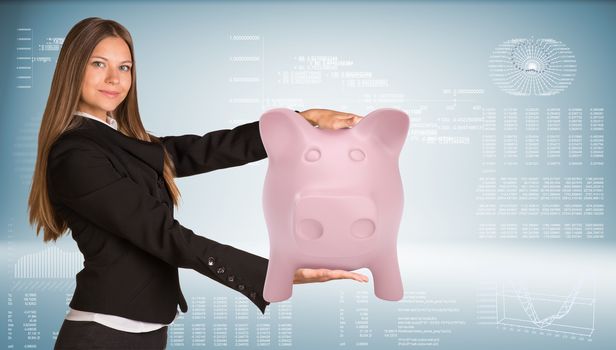 Beautiful businesswoman in suit smiling and holding pink piggy bank. Graph as backdrop