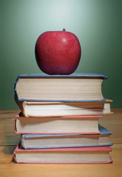 Apple on top of a stack of books 