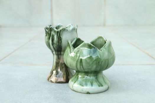 Two of ceramic candlestick on the floor.