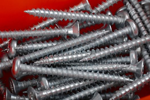 A pile of screws in a box