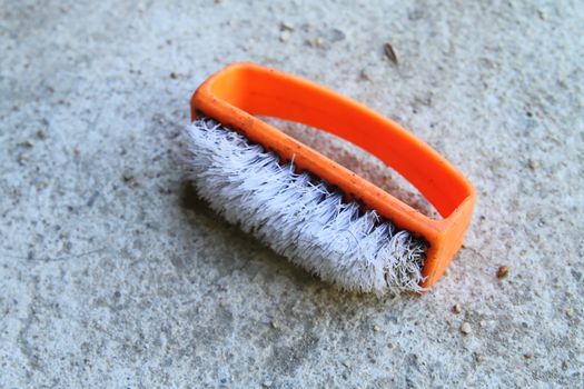 old plastic brush which have the orange handle.