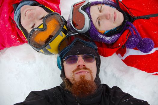 Skiers relaxing in the snow