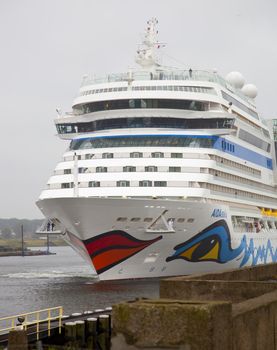 IJMUIDEN, THE NETHERLANDS - JULY 30, 2013: Cruise ship AIDA arrives at lock at IJmuiden, The Netherlands. Cruise ship AIDA is famous for the paintings of eyes and lips.