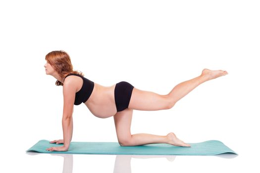 Pregnant woman exerciseing doing yoga. Isolated on white with work path.