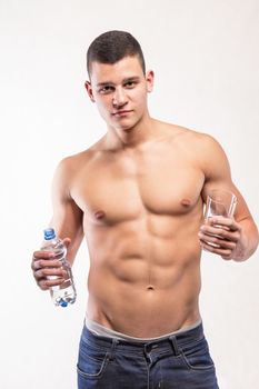 Muscular fitness man holding bottle and wather - studio shoot 