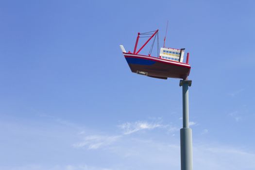 Lighting mast ship on a background of blue sky.