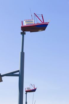 Lighting mast ship on a background of blue sky.