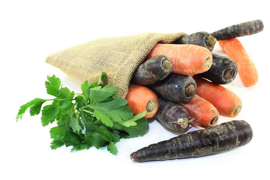 orange and purple carrots in a jute sack