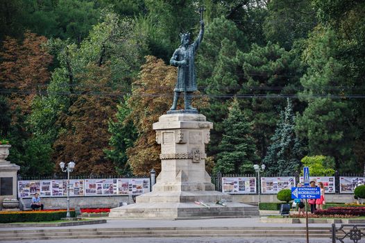 CHISINAU, MOLDOVA, SEPTEMBER 13, 2014. Monument of Stefan cel Mare si Sfant, Stefan the Great and Holy, in Chisinau, Moldova. Stefan the Great was Prince of Moldavia between 1457 and 1504. Political propaganda at the background.