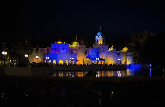 people at watershow in front of lightend castle at the amusement park in holland