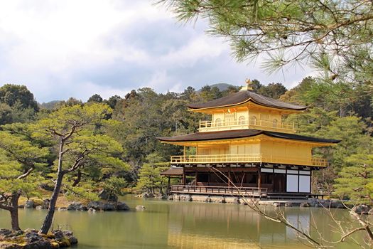 Photo shows old Japanese golden temple in the middle of the park.