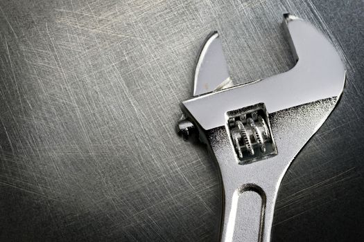 Spanner on steel scratchy background