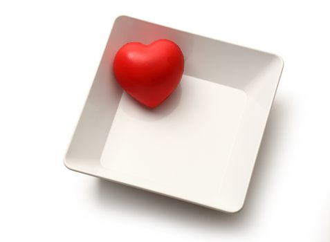 Red heart in white bowl