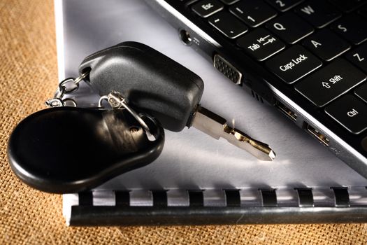 Notebook, car key and computer keyboard