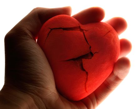 Red broken heart in male hand