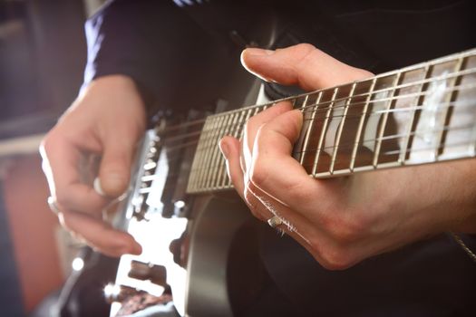 Electric guitar in male hands