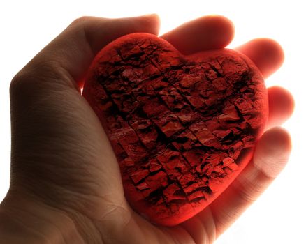 Red stone heart in male hand