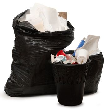 Full black wastebasket and plastic bag