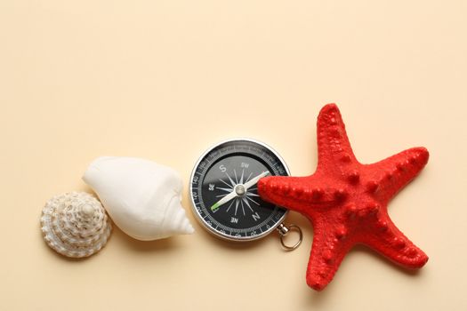 Compass, red seastar and seashells