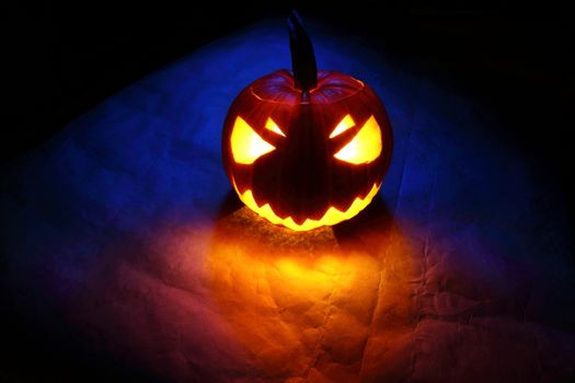 Angry halloween pumpkin in blue light