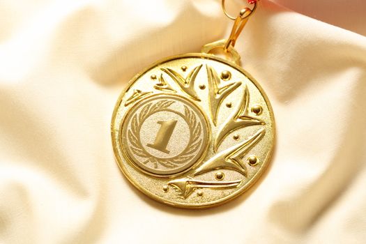 Metal medal on silk wrinkled cloth