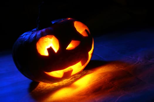 Funny halloween pumpkin in blue light