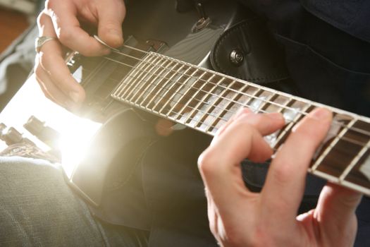 Electric guitar in male hands