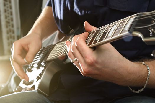 Electric guitar in male hands