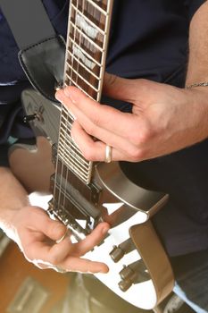 Electric guitar in male hands