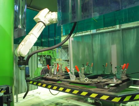 Working welding robot in factory