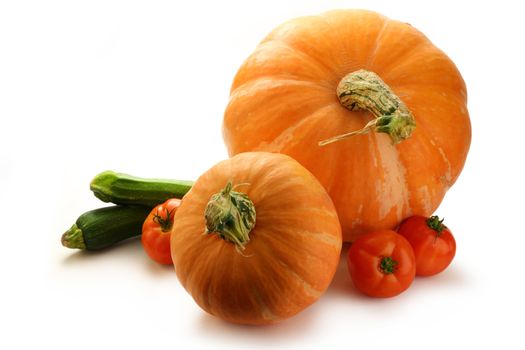 Pumpkins, marrows and tomatoes on white background