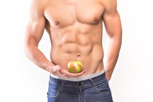 Man muscular torso with apple on hand - studio shoot 