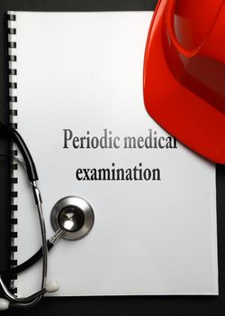 Notebook with red helmet and stethoscope