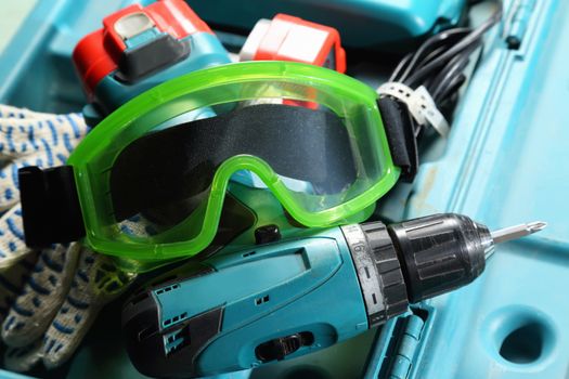 Drill, gloves and goggles in the box 