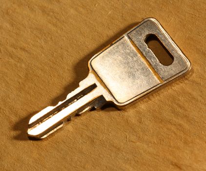 Metal key on paper background