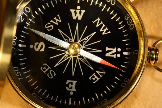 Vintage compass on blank yellowed paper