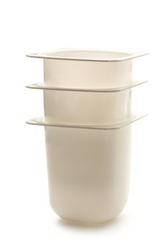 Empty plastic yogurt pots on white