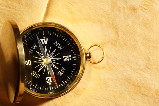 Vintage compass on blank yellowed paper