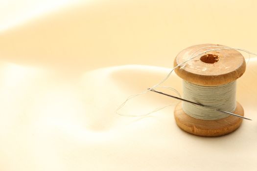 Sewing bobbin and needle on silk cloth