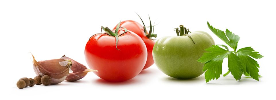 Red and green tomatoes with paprika, parsley and pepper