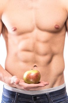 Man muscular torso with apple on hand - studio shoot 