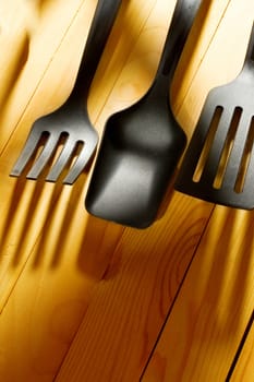 Kitchen utensil collection on wooden background
