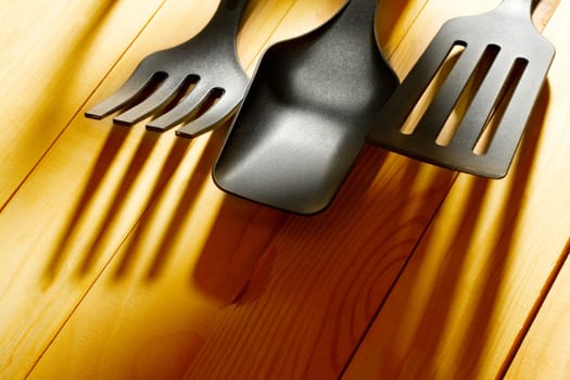 Kitchen utensil collection on wooden background